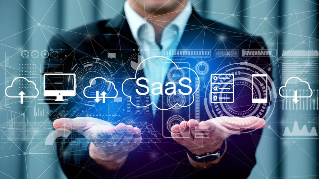 Hands presenting a network of cloud, server, and computer icons with 'SaaS' prominently displayed, representing software integration and business solutions provided by TechVerdi.
