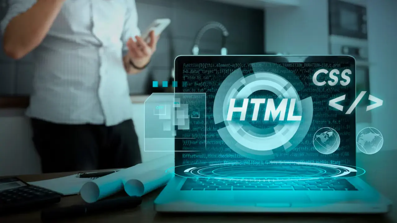 TechVerdi's web development services: HTML & CSS code on a laptop screen theme designed by the TechVerdi US team.